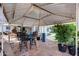 Back patio includes stone flooring, a table and chairs, and yard views at 7210 W Caron Dr, Peoria, AZ 85345