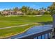 Picturesque backyard with a lush green lawn, serene lake, and beautiful desert landscaping at 7272 E Gainey Ranch Rd # 23, Scottsdale, AZ 85258