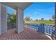 Balcony view overlooking the golf course and lake with lush greenery and blue skies in the background at 7272 E Gainey Ranch Rd # 23, Scottsdale, AZ 85258