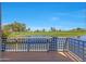 Relaxing view from the balcony of a serene lake and golf course with a clear blue sky at 7272 E Gainey Ranch Rd # 23, Scottsdale, AZ 85258