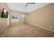 Neutral bedroom with large windows, walk-in closet, ceiling fan, and tile floors at 7272 E Gainey Ranch Rd # 23, Scottsdale, AZ 85258