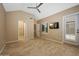 Bedroom featuring tile floors, a ceiling fan, a TV, and access to the outdoor space at 7272 E Gainey Ranch Rd # 23, Scottsdale, AZ 85258