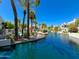 Picturesque community with a pool, water feature, palm trees, and beautifully landscaped common areas at 7272 E Gainey Ranch Rd # 23, Scottsdale, AZ 85258