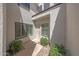 Charming front entrance with neutral walls, decorative shrubbery, and unique architectural details at 7272 E Gainey Ranch Rd # 23, Scottsdale, AZ 85258