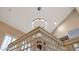 Foyer showcasing a unique decorative railing and statement chandelier at 7272 E Gainey Ranch Rd # 23, Scottsdale, AZ 85258