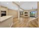 Bright open-concept living room with fireplace, wood flooring, and access to outdoor space at 7272 E Gainey Ranch Rd # 23, Scottsdale, AZ 85258
