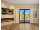 Close-up of the living room fireplace with mounted TV and access to the outdoor views at 7272 E Gainey Ranch Rd # 23, Scottsdale, AZ 85258