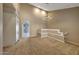 Bright living room featuring neutral walls, decorative railing, and modern chandelier at 7272 E Gainey Ranch Rd # 23, Scottsdale, AZ 85258