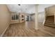 Bright open-concept living room with fireplace, wood flooring, and access to outdoor space at 7272 E Gainey Ranch Rd # 23, Scottsdale, AZ 85258