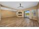 Spacious living room with a modern fireplace and scenic outdoor views through sliding glass doors at 7272 E Gainey Ranch Rd # 23, Scottsdale, AZ 85258