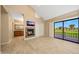 Open living area boasts fireplace, backyard views, and convenient access to the en suite at 7272 E Gainey Ranch Rd # 23, Scottsdale, AZ 85258
