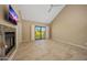 Spacious living room boasts fireplace, tile floors, vaulted ceiling, and slider to backyard at 7272 E Gainey Ranch Rd # 23, Scottsdale, AZ 85258