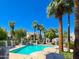 Beautiful community pool surrounded by lush landscaping and inviting lounge chairs under a clear, sunny sky at 7272 E Gainey Ranch Rd # 23, Scottsdale, AZ 85258