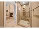 Nicely updated walk-in shower has glass door and stylish tiled walls and convenient toiletry shelf at 7272 E Gainey Ranch Rd # 23, Scottsdale, AZ 85258