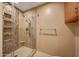 Modern shower features tiled walls, glass enclosure, and built-in shelving at 7272 E Gainey Ranch Rd # 23, Scottsdale, AZ 85258