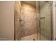 Glass shower with tile accents, brushed fixtures, and ample light at 7272 E Gainey Ranch Rd # 23, Scottsdale, AZ 85258