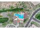 An aerial view of a community pool alongside a golf course and a residential neighborhood at 826 E Buist Ave, Phoenix, AZ 85042