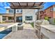Outdoor kitchen and pool area with a built-in barbecue, pergola, and lush landscaping creating an entertainer's dream at 826 E Buist Ave, Phoenix, AZ 85042