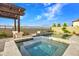 Luxurious backyard with a pool, hot tub, pergola, fire feature, and beautiful landscaping, ideal for outdoor living at 826 E Buist Ave, Phoenix, AZ 85042