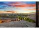 Backyard view features desert landscaping, fire pit, and evening sky at 826 E Buist Ave, Phoenix, AZ 85042