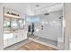 Bright bathroom features a frameless glass shower with subway tile and white double sink vanity at 826 E Buist Ave, Phoenix, AZ 85042