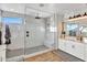 Bright bathroom features a frameless glass shower with subway tile and white double sink vanity at 826 E Buist Ave, Phoenix, AZ 85042