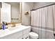 Bathroom with a white vanity, framed mirror, and a neutral shower curtain at 826 E Buist Ave, Phoenix, AZ 85042