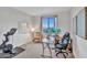 Bedroom featuring a desk with two monitors, chair, exercise bike, and white board at 826 E Buist Ave, Phoenix, AZ 85042