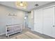Cozy Bedroom with a crib, rug, and closet with sliding doors at 826 E Buist Ave, Phoenix, AZ 85042