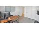 Neutral toned bedroom featuring a long wooden desk and view to the hallway at 826 E Buist Ave, Phoenix, AZ 85042