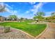 Lush community park featuring native landscaping, green grass, walking paths, and neighborhood homes at 826 E Buist Ave, Phoenix, AZ 85042