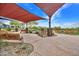 Outdoor seating area with shade structure, benches, native landscaping, and walking paths at 826 E Buist Ave, Phoenix, AZ 85042