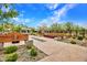 Inviting outdoor space featuring stone and wood benches, walkways, gravel, and colorful landscaping at 826 E Buist Ave, Phoenix, AZ 85042