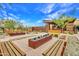 Inviting outdoor space featuring stone and wood benches, walkways, and fire features with gravel beds at 826 E Buist Ave, Phoenix, AZ 85042