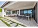 Inviting covered patio featuring comfortable seating, an outdoor dining area, and seamless indoor-outdoor living at 826 E Buist Ave, Phoenix, AZ 85042