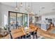 Bright dining room with wood table, modern lighting, and sliding glass doors to outdoor area at 826 E Buist Ave, Phoenix, AZ 85042