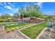 Beautifully landscaped community entrance featuring desert vegetation, decorative stone walls, and signage at 826 E Buist Ave, Phoenix, AZ 85042