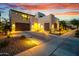Modern home with stone accents, desert landscaping, and a two-car garage at sunset at 826 E Buist Ave, Phoenix, AZ 85042