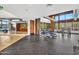 Community gym featuring free weights, stone accent walls, light wood trim, and floor-to-ceiling windows at 826 E Buist Ave, Phoenix, AZ 85042