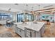 Open concept kitchen with island, farmhouse sink, stainless appliances, and hardwood floors at 826 E Buist Ave, Phoenix, AZ 85042