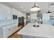 Modern kitchen boasts sleek countertops, white cabinets, and a large central island with barstool seating at 826 E Buist Ave, Phoenix, AZ 85042
