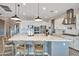 Spacious kitchen featuring a large island with seating, modern appliances, and stylish pendant lighting at 826 E Buist Ave, Phoenix, AZ 85042