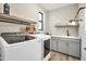 Spacious laundry room with cabinets, sink, and modern washer and dryer at 826 E Buist Ave, Phoenix, AZ 85042