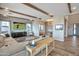 Comfortable living room with entertainment center, wood beam ceilings, and open access to office area at 826 E Buist Ave, Phoenix, AZ 85042