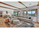 Spacious living room with hardwood floors, ample seating, open floor plan, and backyard view at 826 E Buist Ave, Phoenix, AZ 85042