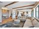 Bright and airy living room featuring wood beam ceilings, stylish decor, and an open floor plan at 826 E Buist Ave, Phoenix, AZ 85042