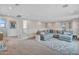 Spacious upstairs loft area with a sectional sofa, carpet, and natural light at 826 E Buist Ave, Phoenix, AZ 85042