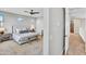 Stylish main bedroom with bench, ceiling fan, and neutral color scheme at 826 E Buist Ave, Phoenix, AZ 85042