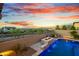 This pool has an elegant waterfall feature cascading into it and desert views for a relaxing ambiance at 826 E Buist Ave, Phoenix, AZ 85042