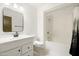 Bright bathroom featuring a white vanity, matching toilet, and shower-tub combination at 10468 W Palmeras Dr, Sun City, AZ 85373